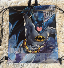 Load image into Gallery viewer, Batman in flight drawstring bag, cities buildings in background, says "dark knight", black handle