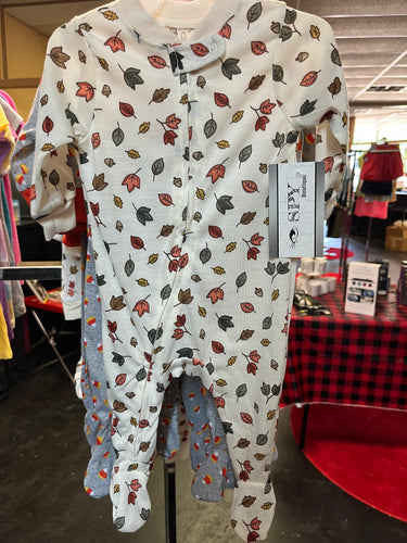 Fall themed onesie, white background with green, yellow, and brown leaves
