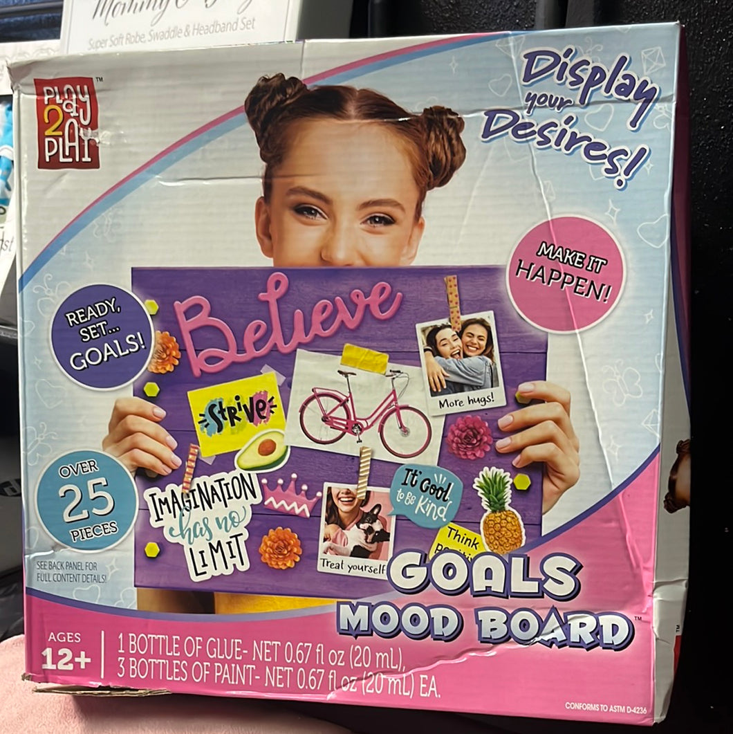 little girl holding a mood board